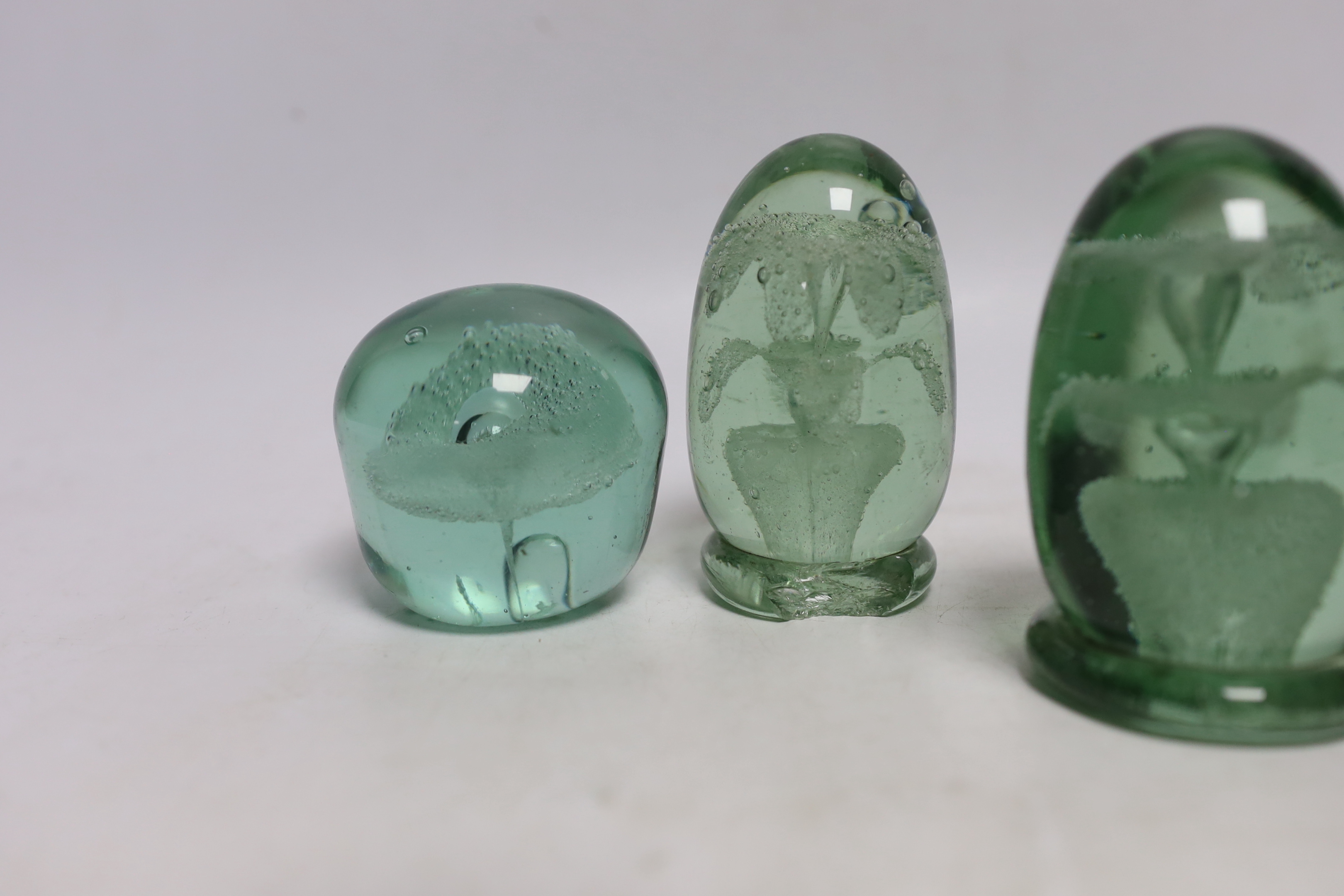 Five green glass dumps, including two with inset sulphides, tallest 9cm